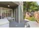 Enclosed outdoor patio area featuring a bench, door, and trees at 1106 Rock Creek Ln, Norcross, GA 30093