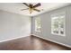 Cozy bedroom featuring wood floors, standard ceiling fan and natural light from two windows at 274 Westchester Club Dr, Hiram, GA 30141