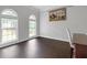 Bright bedroom with hardwood floors, large arched windows, and a decorative tapestry at 274 Westchester Club Dr, Hiram, GA 30141