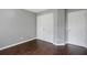 Simple bedroom features hardwood floors, light gray walls, and closet with standard doors at 274 Westchester Club Dr, Hiram, GA 30141