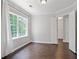 Bedroom features a window, hardwood floors and a view into the ensuite bathroom at 274 Westchester Club Dr, Hiram, GA 30141