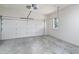 Clean, empty garage featuring a white garage door and walls and a single window at 274 Westchester Club Dr, Hiram, GA 30141