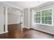 Living room features dark wood floors, columns, a large window and views into other rooms at 274 Westchester Club Dr, Hiram, GA 30141