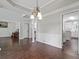 Open-concept living area featuring hardwood floors, white columns, and an adjoining kitchen at 274 Westchester Club Dr, Hiram, GA 30141