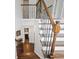 An interior view of a hardwood staircase with iron balusters leading to the upper level at 274 Westchester Club Dr, Hiram, GA 30141
