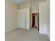 This bedroom showcases neutral carpet and walls along with entry to another room at 83 Brookway Trce, Norcross, GA 30071