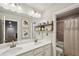Bathroom featuring double sinks, a large mirror, and a bathtub with shower at 244 Lotus Cir, Mcdonough, GA 30252