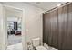 Bathroom with standard fixtures, featuring a toilet, a shower curtain, and a view into the bedroom at 244 Lotus Cir, Mcdonough, GA 30252