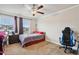 Cozy bedroom with ample natural light, carpeted floors, and a ceiling fan at 244 Lotus Cir, Mcdonough, GA 30252