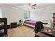 Simple bedroom with minimal decor, featuring carpeted floors, ceiling fan, and closet at 244 Lotus Cir, Mcdonough, GA 30252