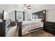 Comfortable bedroom with a large bed, TV, dresser, ceiling fan, and cozy chair at 244 Lotus Cir, Mcdonough, GA 30252