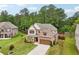 Two-story brick home with manicured lawn, mature trees, and a paved driveway at 244 Lotus Cir, Mcdonough, GA 30252