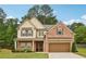 Charming two-story brick home with a well-manicured lawn and attached two-car garage at 244 Lotus Cir, Mcdonough, GA 30252