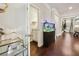Bright hallway with hardwood floors, leading to powder room and living spaces at 244 Lotus Cir, Mcdonough, GA 30252