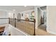 Upstairs landing featuring hardwood railings, open floor plan, and neutral carpet at 244 Lotus Cir, Mcdonough, GA 30252