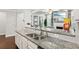 Open kitchen with a large granite countertop island and stainless steel sink at 244 Lotus Cir, Mcdonough, GA 30252