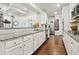 Bright kitchen with white cabinetry, stainless steel appliances, and granite countertops at 244 Lotus Cir, Mcdonough, GA 30252
