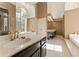 Bathroom with a marble vanity, soaking tub and natural lighting at 607 Delphinium Nw Blvd, Acworth, GA 30102