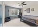 Cozy bedroom with a large window, blue accent wall and neutral carpet at 607 Delphinium Nw Blvd, Acworth, GA 30102