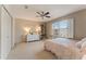 Bright bedroom featuring a white dresser, carpet, and a large window at 607 Delphinium Nw Blvd, Acworth, GA 30102