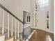 Inviting foyer with hardwood floors, staircase, and a large window above the front door at 607 Delphinium Nw Blvd, Acworth, GA 30102