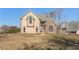 Two-story home with a blend of stucco and stone, arched windows, and a well-manicured lawn at 607 Delphinium Nw Blvd, Acworth, GA 30102