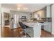 Kitchen island with bar stool seating, stainless appliances, and hardwood floors at 607 Delphinium Nw Blvd, Acworth, GA 30102