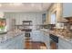 Kitchen with granite countertops, stainless steel appliances, and stylish backsplash at 607 Delphinium Nw Blvd, Acworth, GA 30102