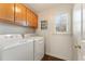 Functional laundry room with a modern washer and dryer and built-in cabinets at 607 Delphinium Nw Blvd, Acworth, GA 30102
