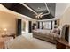 Primary bedroom featuring a dramatic tray ceiling and luxurious finishes at 607 Delphinium Nw Blvd, Acworth, GA 30102