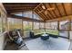 Cozy screened porch with comfortable seating, ceiling fan, and exercise equipment at 607 Delphinium Nw Blvd, Acworth, GA 30102