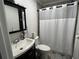 Bathroom featuring a toilet, sink, and walk-in shower at 733 Linda Way, Forest Park, GA 30297