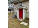 Access door to basement with peeling red paint and concrete steps next to AC unit at 733 Linda Way, Forest Park, GA 30297