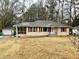 Cozy, single-story home featuring a screened-in porch, tidy front yard, and quaint architectural details at 733 Linda Way, Forest Park, GA 30297