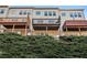 Exterior view from below, showing the back of the building with attached decks and green foliage in front at 2722 Hallwood Ln, Suwanee, GA 30024