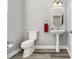Cozy powder room featuring neutral walls, a pedestal sink, and modern fixtures at 2722 Hallwood Ln, Suwanee, GA 30024