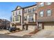 Attractive brick townhome showcasing a private garage, front door, and appealing architectural design at 2722 Hallwood Ln, Suwanee, GA 30024