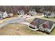 Aerial view showcases a well-maintained home in a cul-de-sac surrounded by other homes and trees at 28 Butler Park Ct, Dallas, GA 30157
