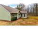 Back exterior featuring an enclosed sunroom, vinyl siding, and a spacious lawn at 28 Butler Park Ct, Dallas, GA 30157