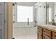 Luxurious bathroom with a glass-enclosed shower, marble tiling, and a granite vanity at 28 Butler Park Ct, Dallas, GA 30157