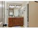 Bathroom featuring double sinks, granite countertops, wood cabinets, and a walk-in shower at 28 Butler Park Ct, Dallas, GA 30157