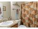 Well-lit bathroom featuring a shower with patterned curtain at 28 Butler Park Ct, Dallas, GA 30157