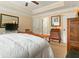Comfortable bedroom boasting neutral walls and carpet with a white comforter on the wooden bed frame at 28 Butler Park Ct, Dallas, GA 30157