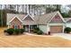Inviting single-story home with manicured lawn, stone details, and convenient two-car garage at 28 Butler Park Ct, Dallas, GA 30157