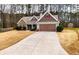 Attractive single-story home featuring stone accents, a long driveway, and a two-car garage at 28 Butler Park Ct, Dallas, GA 30157