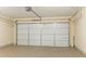 Well-lit garage featuring a white door, epoxy flooring, and ample space for parking and storage at 28 Butler Park Ct, Dallas, GA 30157