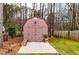Durable wood shed in a backyard with trees, offering extra storage for any homeowner at 28 Butler Park Ct, Dallas, GA 30157