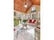 Bright sunroom with vaulted wood ceiling, area rug and plenty of natural light at 28 Butler Park Ct, Dallas, GA 30157