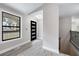 Bright entryway with gray walls, modern front door with sidelights, and a staircase leading to the upper level at 2995 Clearwater Dr, Douglasville, GA 30135