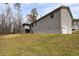 View of home exterior with a 2-car garage and a sloping lawn leading up to the house at 2995 Clearwater Dr, Douglasville, GA 30135